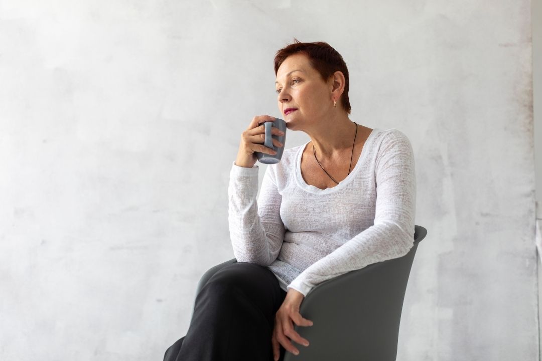 Persona en casa en un momento de pausa y reflexión, representando acompañamiento emocional y bienestar emocional